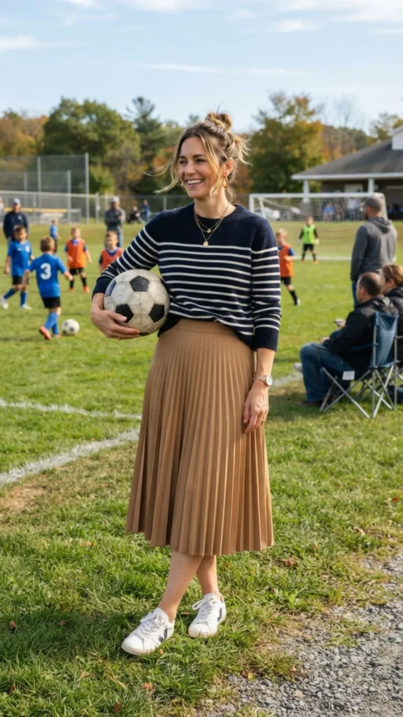 Breton stripe sweater with a camel midi skirt for a timeless Parisian-inspired look.