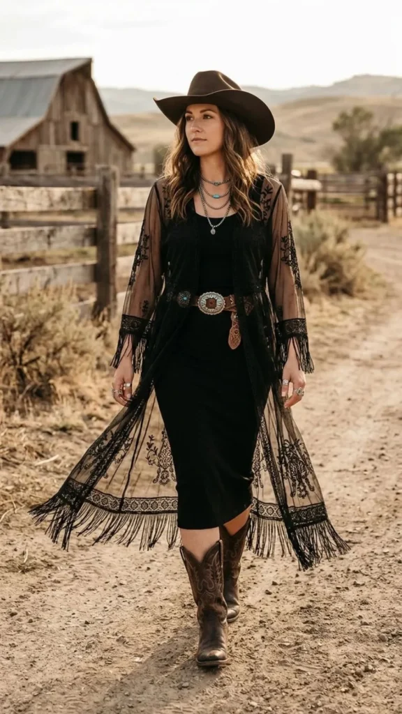 Elegant black dress layered with a sheer duster and cowboy boots for a chic Western-inspired look.